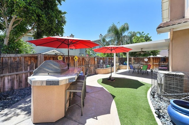 11180 Bridgefield Ct, Riverside, CA 92505 - fenced backyard with a patio area and exterior kitchen
