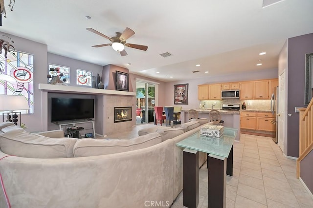 11180 Bridgefield Ct, Riverside, CA 92505 - living room featuring light tile patterned floors, ceiling fan, recessed lighting, and a tile fireplace