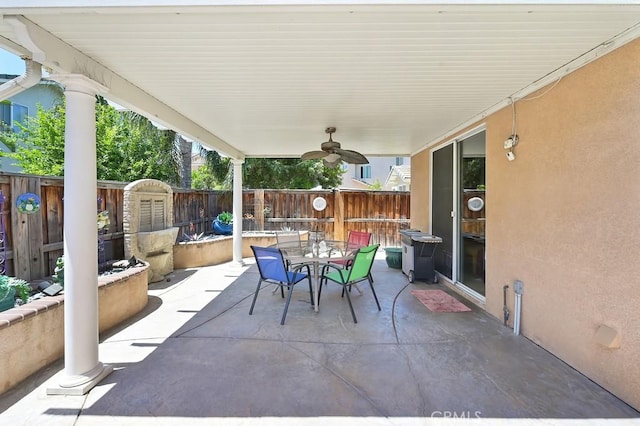 11180 Bridgefield Ct, Riverside, CA 92505 - fenced backyard with a patio, outdoor dining area, and a ceiling fan