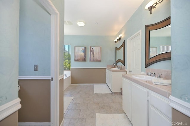 11180 Bridgefield Ct, Riverside, CA 92505 - bathroom featuring stone finish flooring, two vanities, and a bath