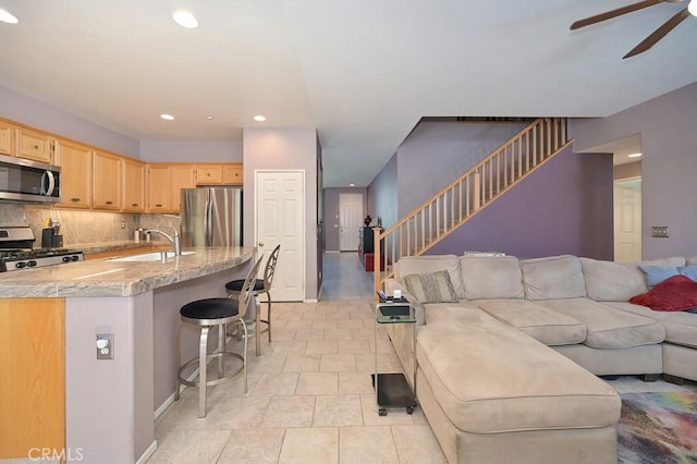 11180 Bridgefield Ct, Riverside, CA 92505 - kitchen featuring appliances with stainless steel finishes, light brown cabinets, a ceiling fan, recessed lighting, and open floor plan