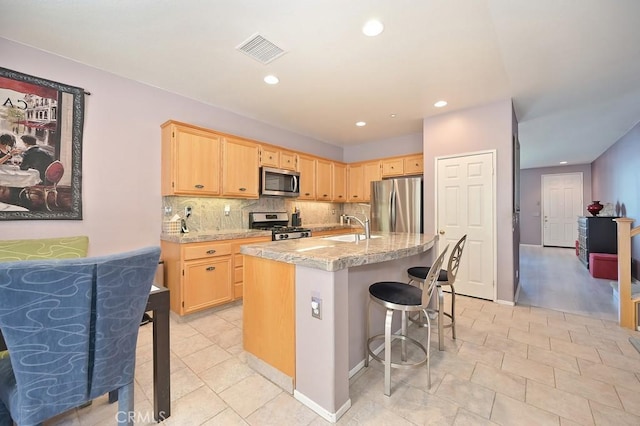 11180 Bridgefield Ct, Riverside, CA 92505 - kitchen featuring appliances with stainless steel finishes, light brown cabinetry, light countertops, tasteful backsplash, and recessed lighting