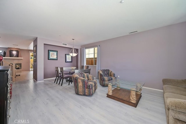 11180 Bridgefield Ct, Riverside, CA 92505 - living area featuring wood finished floors and a lit fireplace