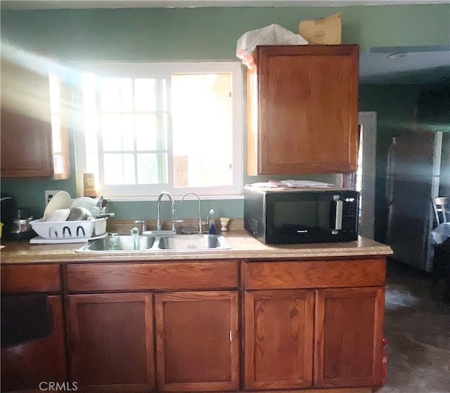 1130 S Rene Dr, Santa Ana, CA 92704 - kitchen with black microwave, brown cabinets, and light countertops