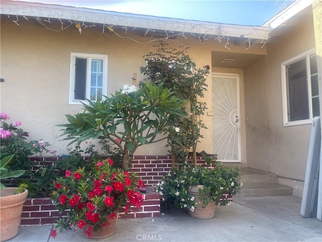 1130 S Rene Dr, Santa Ana, CA 92704 - view of exterior entry featuring stucco siding