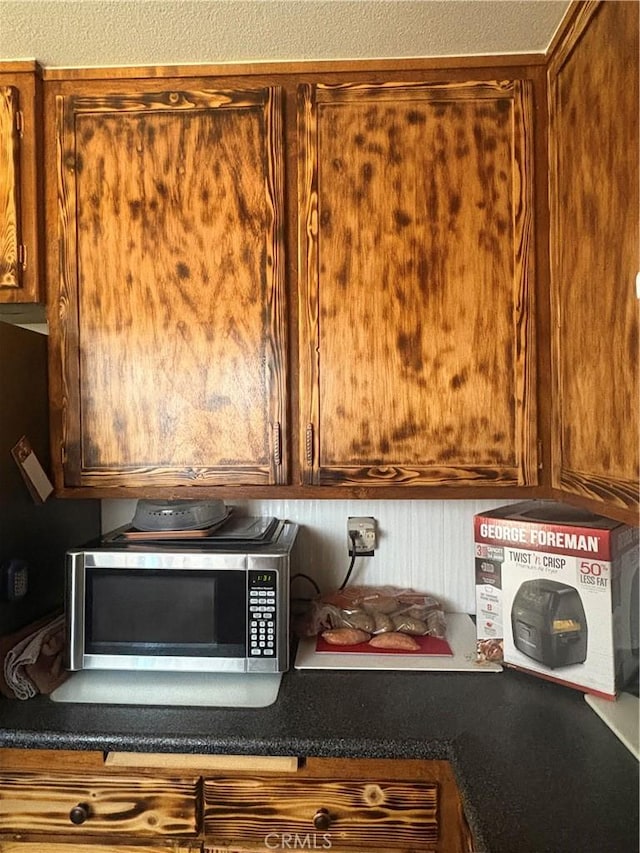7103 Hanford Ave, Yucca Valley, CA 92284 - kitchen view of stainless steel microwave and dark countertops