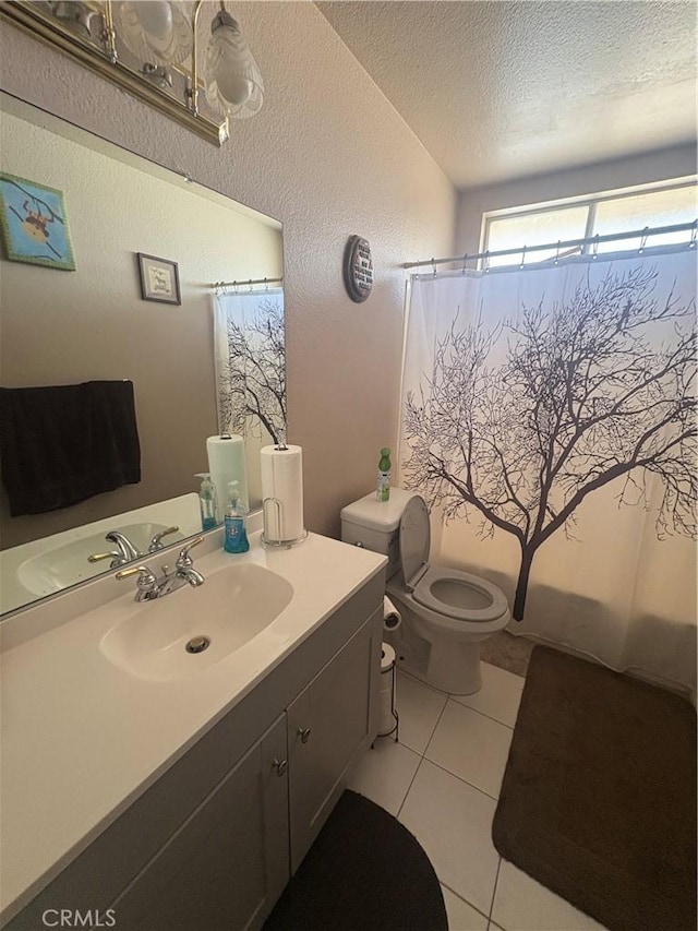 7103 Hanford Ave, Yucca Valley, CA 92284 - full bath featuring a textured ceiling, vanity, tile patterned floors, a shower with curtain, and a textured wall