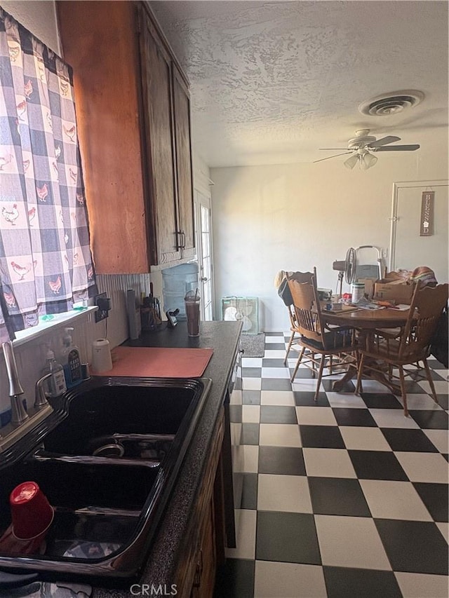 7103 Hanford Ave, Yucca Valley, CA 92284 - kitchen featuring dark floors, a ceiling fan, and a textured ceiling