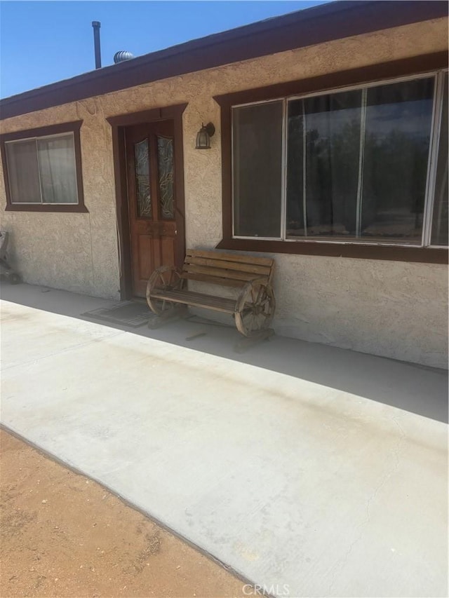 7103 Hanford Ave, Yucca Valley, CA 92284 - view of exterior entry featuring stucco siding
