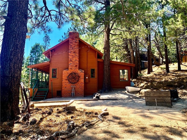 33140 Juniper Ln, Green Valley Lake, CA 92341 - rear view of house featuring a chimney