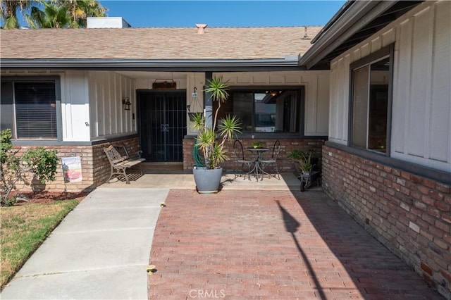 3134 Half Circle Rd, Norco, CA 92860 - entrance to property featuring a shingled roof, brick siding, and a patio