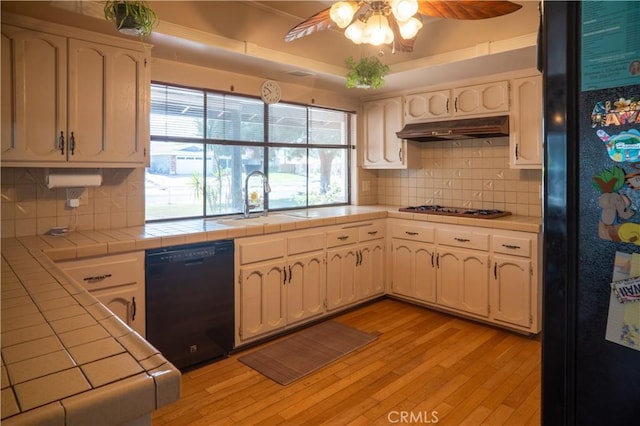 3134 Half Circle Rd, Norco, CA 92860 - kitchen with black appliances, tile countertops, under cabinet range hood, and light wood finished floors