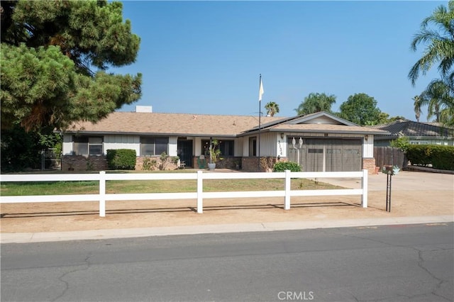 3134 Half Circle Rd, Norco, CA 92860 - ranch-style house featuring concrete driveway, an attached garage, a fenced front yard, and brick siding
