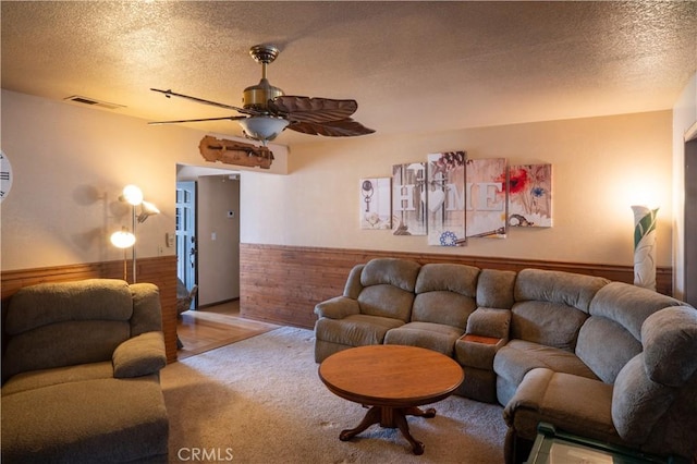 3134 Half Circle Rd, Norco, CA 92860 - living room with a textured ceiling, ceiling fan, wainscoting, carpet, and wood walls