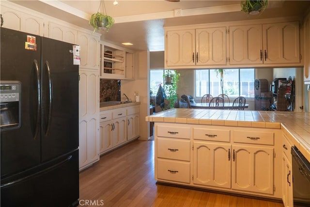 3134 Half Circle Rd, Norco, CA 92860 - kitchen featuring black appliances, tile countertops, light wood-type flooring, plenty of natural light, and crown molding