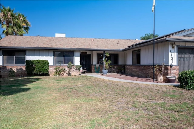 3134 Half Circle Rd, Norco, CA 92860 - ranch-style home with brick siding, board and batten siding, and a front yard