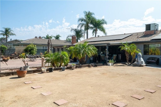 3134 Half Circle Rd, Norco, CA 92860 - rear view of house with solar panels, a patio, and a chimney