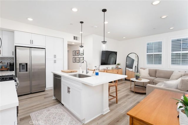 11046 Wander Dr, Rancho Cucamonga, CA 91730 - kitchen with appliances with stainless steel finishes, open floor plan, white cabinetry, light wood-type flooring, and recessed lighting