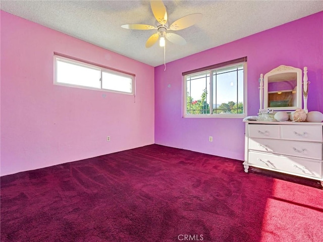 346 E Plymouth St, Glendora, CA 91740 - unfurnished bedroom with multiple windows, dark carpet, a textured ceiling, and ceiling fan