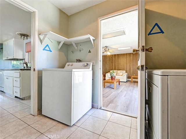 346 E Plymouth St, Glendora, CA 91740 - laundry room with washer / dryer, a ceiling fan, light tile patterned floors, and wood walls