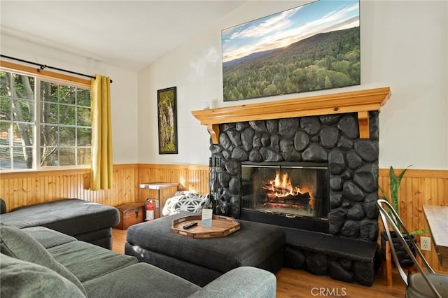 1348 Manzanita Way, Lake Arrowhead, CA 92352 - living room with wooden walls, a wainscoted wall, vaulted ceiling, wood finished floors, and a stone fireplace