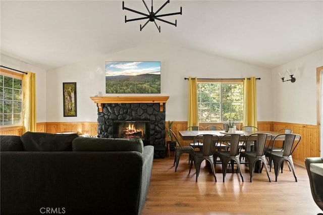 1348 Manzanita Way, Lake Arrowhead, CA 92352 - dining room featuring a wainscoted wall, vaulted ceiling, wood walls, a stone fireplace, and wood finished floors