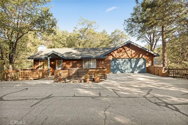 1348 Manzanita Way, Lake Arrowhead, CA 92352 - rustic home with concrete driveway, a garage, and a chimney