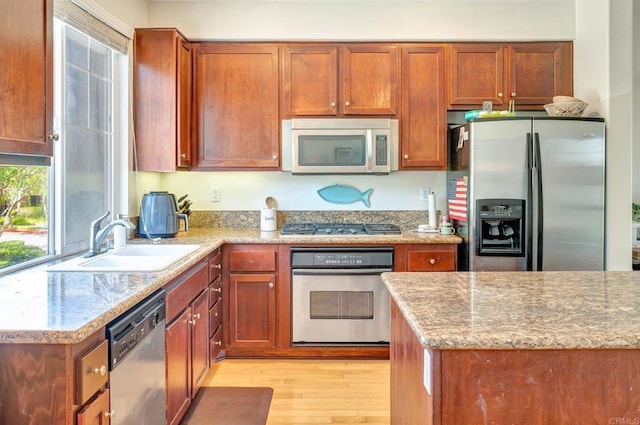 14658 Via Fiesta Unit 2, San Diego, CA 92127 - kitchen featuring appliances with stainless steel finishes, light wood-style flooring, and brown cabinetry