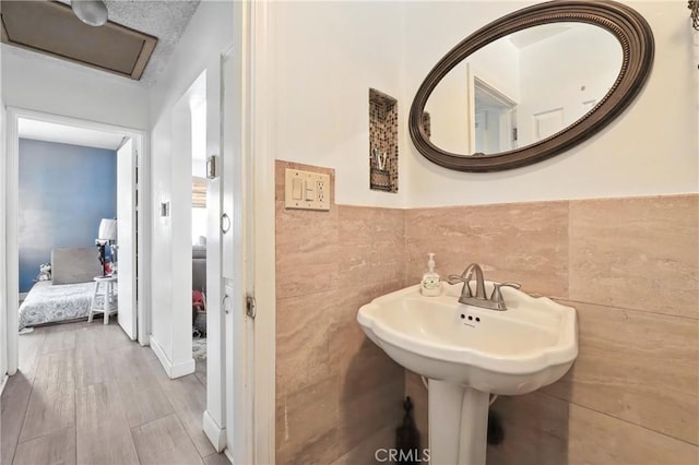 123 E Andrix St, Monterey Park, CA 91755 - bathroom with tile walls, wood finished floors, and a wainscoted wall