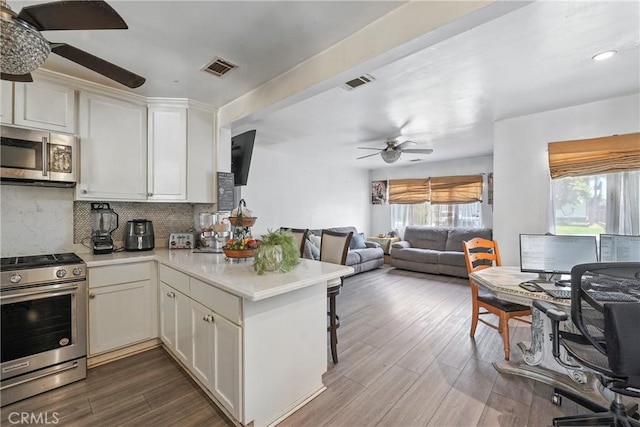 123 E Andrix St, Monterey Park, CA 91755 - kitchen featuring appliances with stainless steel finishes, a ceiling fan, a peninsula, open floor plan, and light countertops