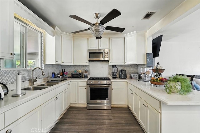 123 E Andrix St, Monterey Park, CA 91755 - kitchen featuring stainless steel appliances, a peninsula, a ceiling fan, light countertops, and tasteful backsplash