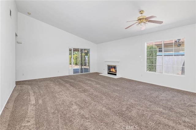 1083 Mill Iron Way, San Jacinto, CA 92583 - unfurnished living room featuring carpet flooring, ceiling fan, lofted ceiling, a glass covered fireplace, and healthy amount of natural light