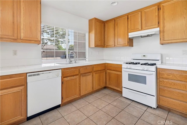 1083 Mill Iron Way, San Jacinto, CA 92583 - kitchen with white appliances, under cabinet range hood, light tile patterned floors, and tile countertops