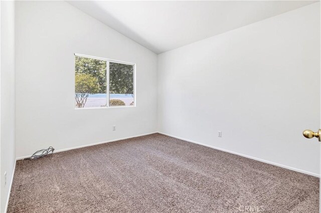 1083 Mill Iron Way, San Jacinto, CA 92583 - carpeted spare room with vaulted ceiling and baseboards
