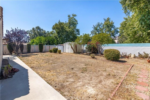 1083 Mill Iron Way, San Jacinto, CA 92583 - fenced backyard with a storage unit