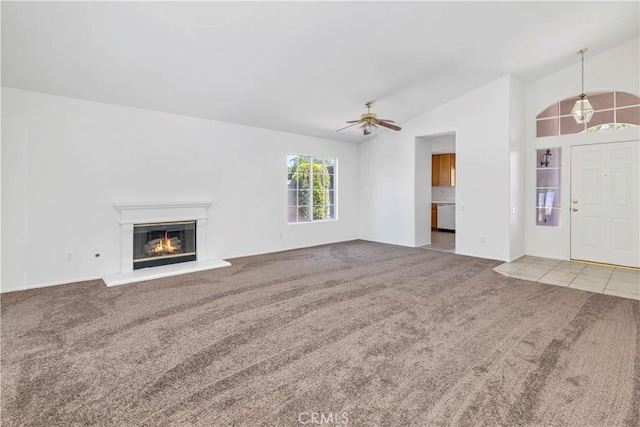 1083 Mill Iron Way, San Jacinto, CA 92583 - unfurnished living room with carpet flooring, lofted ceiling, ceiling fan, and a glass covered fireplace