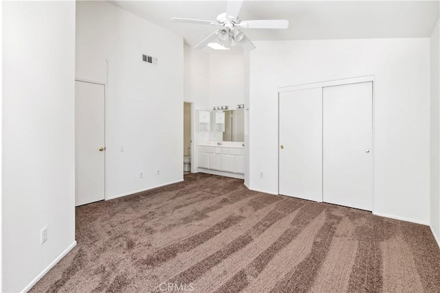 1083 Mill Iron Way, San Jacinto, CA 92583 - unfurnished bedroom with carpet, ensuite bath, a ceiling fan, and a closet