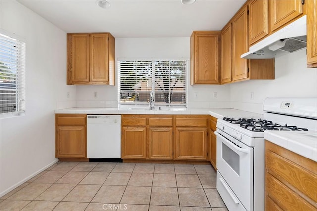 1083 Mill Iron Way, San Jacinto, CA 92583 - kitchen with white appliances, under cabinet range hood, plenty of natural light, and tile countertops