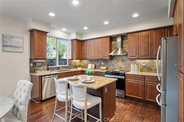 28889 Edenton Way, Temecula, CA 92591 - kitchen featuring stainless steel appliances, wall chimney range hood, dark wood-type flooring, a breakfast bar area, and recessed lighting