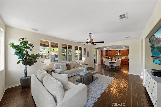 28889 Edenton Way, Temecula, CA 92591 - living area featuring dark wood-style flooring, ceiling fan, and arched walkways