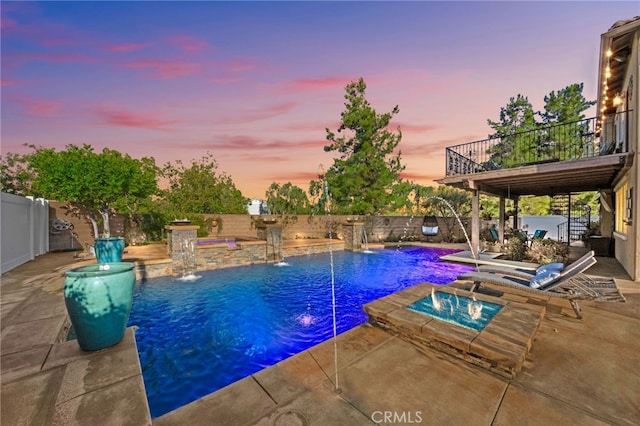28889 Edenton Way, Temecula, CA 92591 - pool at dusk featuring an in-ground hot tub, a fenced backyard, and a patio