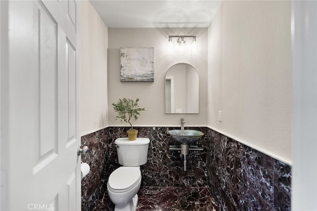 28889 Edenton Way, Temecula, CA 92591 - half bathroom featuring marble look tile flooring, wainscoting, and tile walls