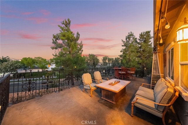 28889 Edenton Way, Temecula, CA 92591 - patio terrace at dusk featuring an outdoor fire pit and a patio