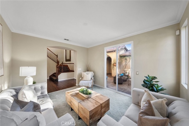 28889 Edenton Way, Temecula, CA 92591 - living room featuring arched walkways, stairway, crown molding, and wood finished floors