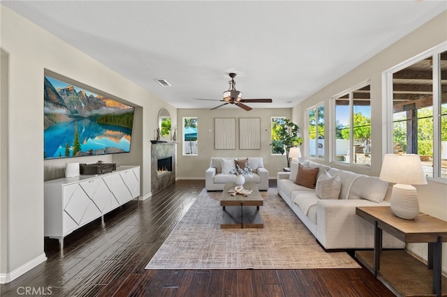 28889 Edenton Way, Temecula, CA 92591 - living area featuring a lit fireplace, a ceiling fan, and hardwood / wood-style flooring