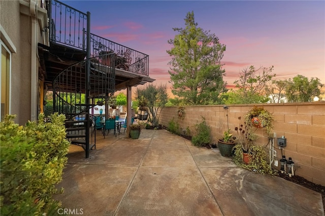 28889 Edenton Way, Temecula, CA 92591 - patio terrace at dusk with stairs, a patio, and a fenced backyard