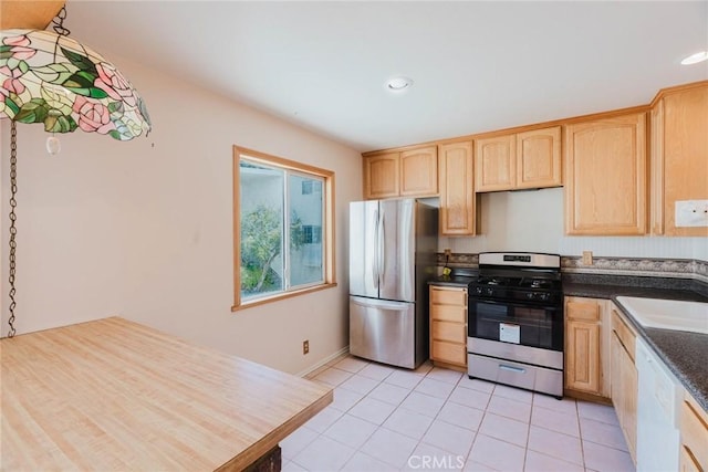 9576 Via Bernardo, Burbank, CA 91504 - kitchen with appliances with stainless steel finishes, light brown cabinetry, light tile patterned floors, dark countertops, and recessed lighting