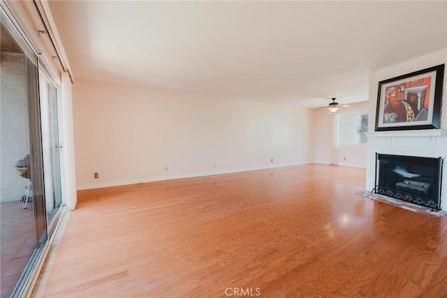 9576 Via Bernardo, Burbank, CA 91504 - unfurnished living room featuring a fireplace with flush hearth, light wood finished floors, and ceiling fan