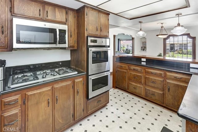 239 Nieto Ave Unit A, Long Beach, CA 90803 - kitchen featuring stainless steel appliances, dark countertops, light flooring, and brown cabinetry