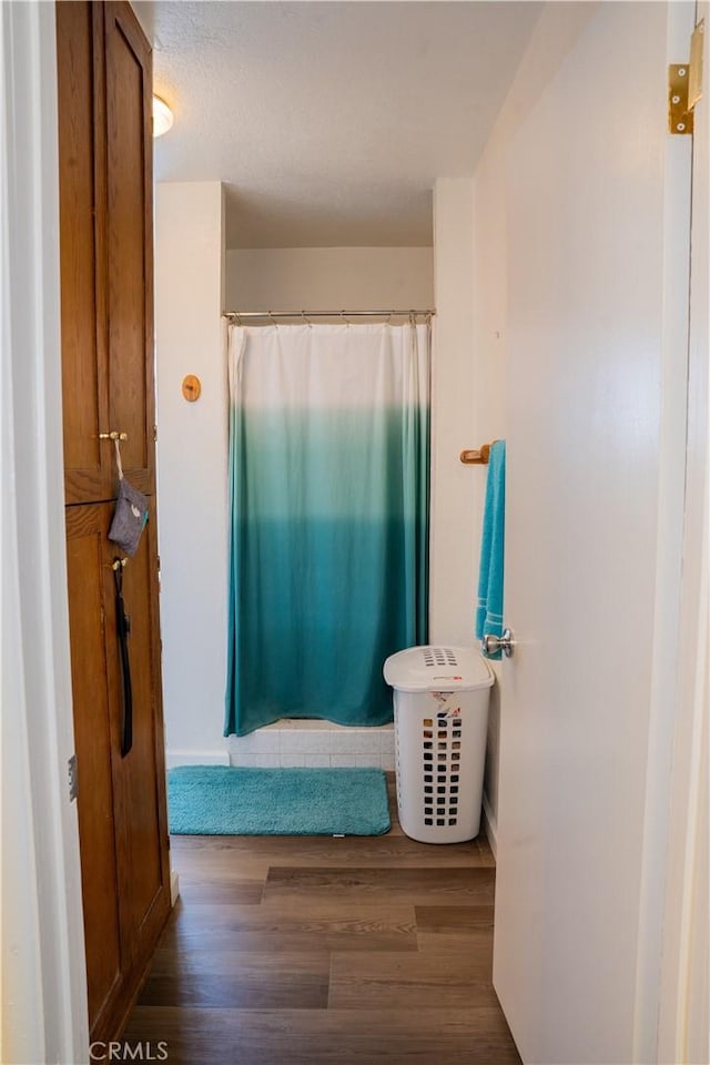 10515 Acoro St, Bellflower, CA 90706 - full bathroom featuring wood finished floors and a shower with shower curtain